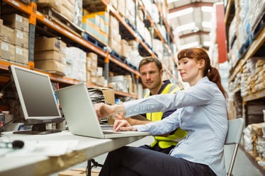 man and woman assessing warehouse management