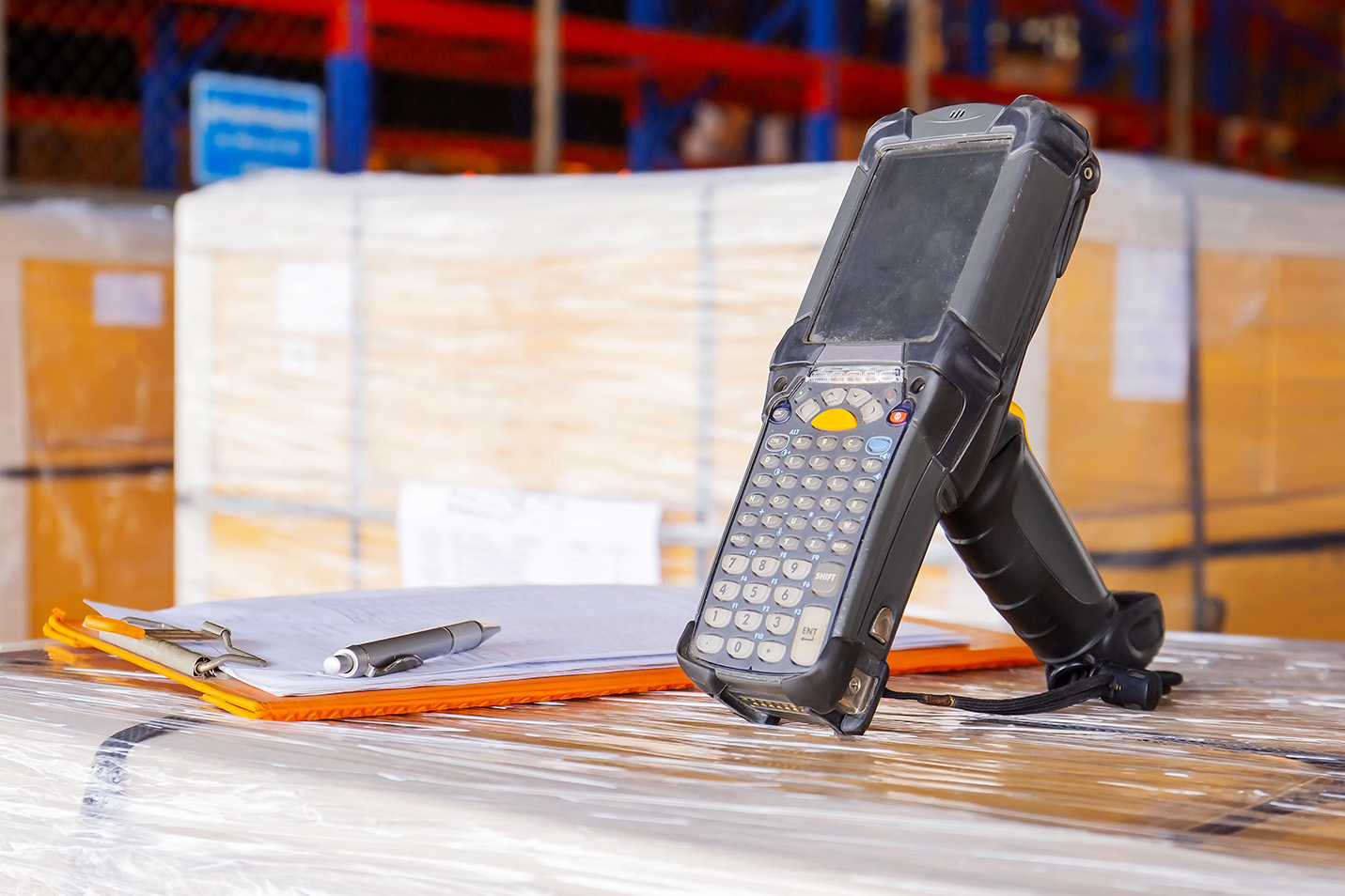 Warehouse handheld beside checklist during contract negotiations